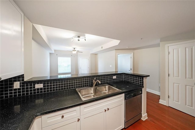 kitchen with decorative backsplash, dishwasher, wood-type flooring, and white cabinets