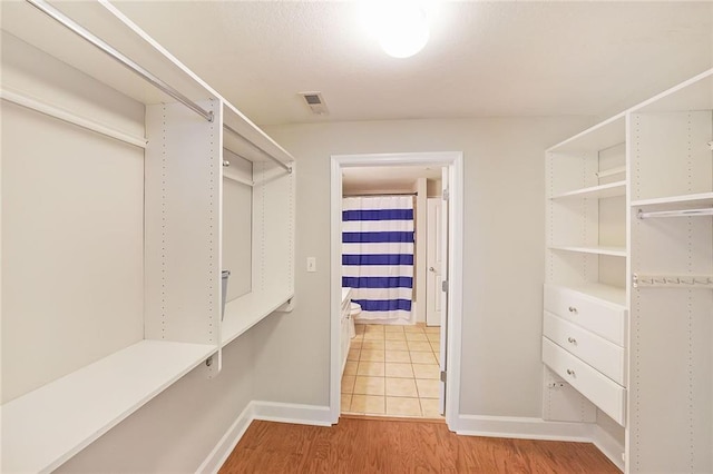 spacious closet featuring light hardwood / wood-style floors