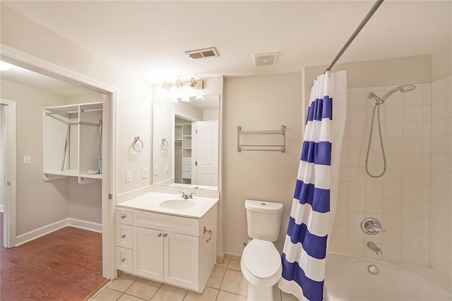 full bathroom featuring shower / bath combination with curtain, tile patterned flooring, vanity, and toilet