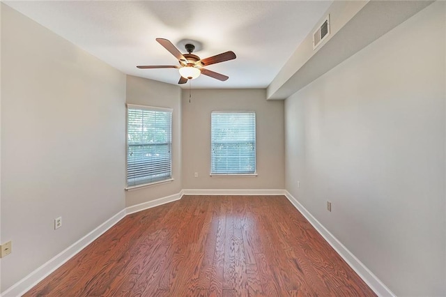 unfurnished room with ceiling fan and dark wood-type flooring