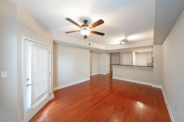 unfurnished living room featuring ceiling fan and hardwood / wood-style flooring