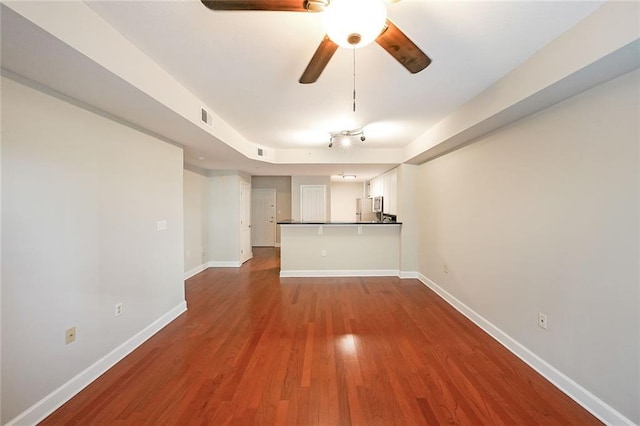 230 E Ponce De Leon Ave Unit 314, Decatur, GA 30030 - unfurnished living room featuring ceiling fan, dark wood-style flooring, and baseboards