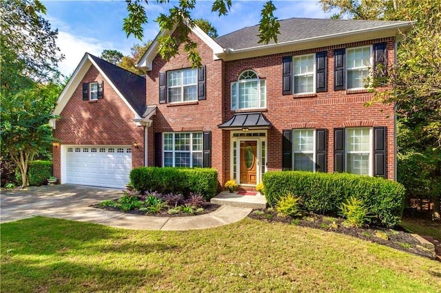 2540 Ridgehurst Dr, Buford, GA 30518 - colonial home featuring brick siding, concrete driveway, a front yard, and roof with shingles