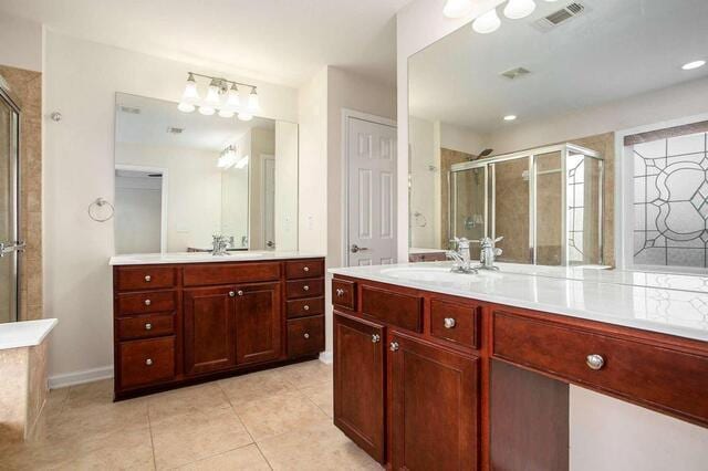 bathroom with vanity, tile patterned flooring, and a shower with shower door