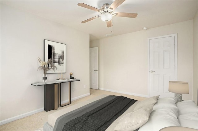 bedroom with ceiling fan and light colored carpet