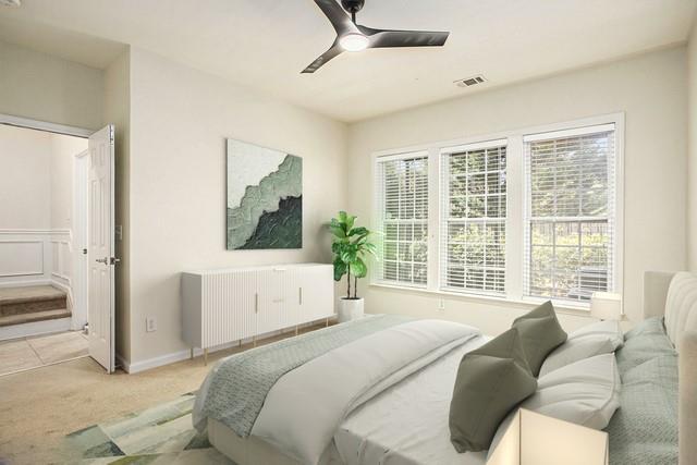 bedroom featuring radiator, light colored carpet, and ceiling fan