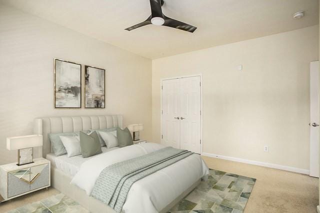 carpeted bedroom featuring ceiling fan and a closet