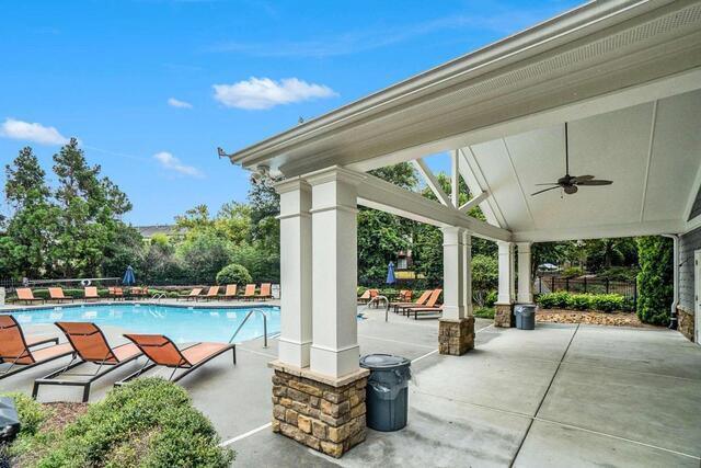 view of swimming pool featuring a patio and ceiling fan