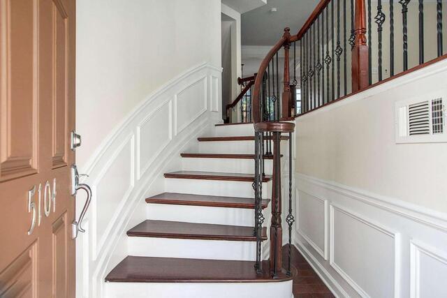 staircase featuring wood-type flooring