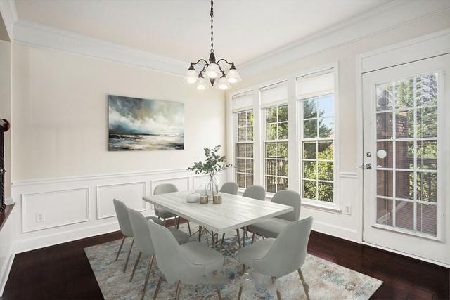 dining area featuring crown molding, dark wood-type flooring, and a chandelier