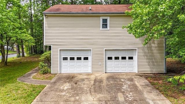 garage featuring concrete driveway