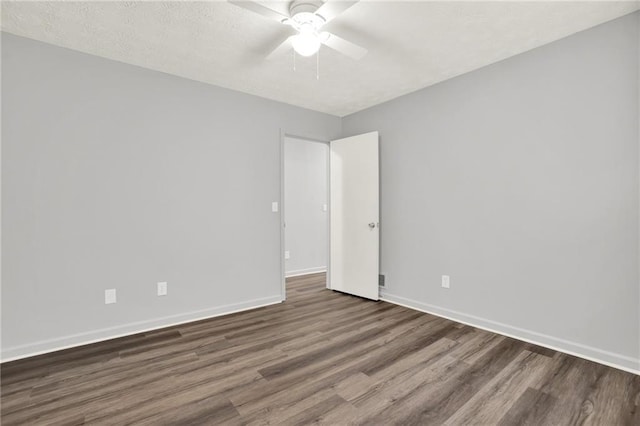 unfurnished room featuring wood finished floors, baseboards, ceiling fan, and a textured ceiling