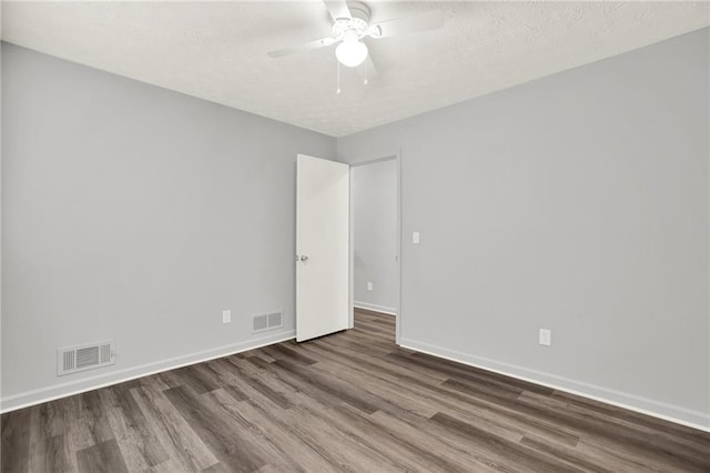 unfurnished room with wood finished floors, baseboards, and ceiling fan