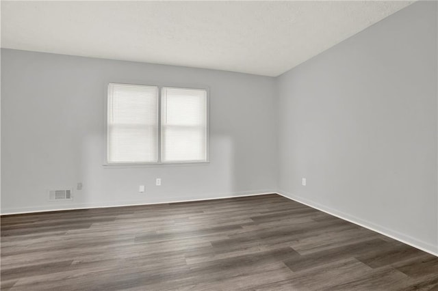 unfurnished room featuring wood finished floors and baseboards
