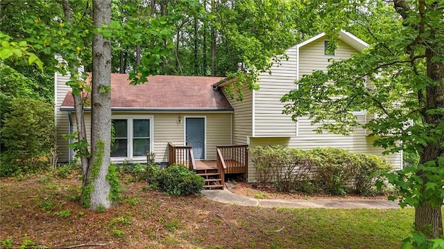 back of house featuring a deck and a chimney