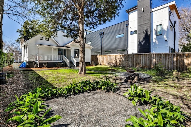 back of house with a porch and fence