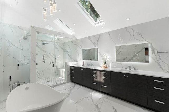 4070 Whitewater Creek Rd, Atlanta, GA 30327 - bathroom featuring a skylight, double vanity, stone wall, and a freestanding bath