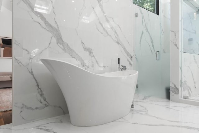 4070 Whitewater Creek Rd, Atlanta, GA 30327 - full bath with ensuite bath, a marble finish shower, stone wall, and a soaking tub
