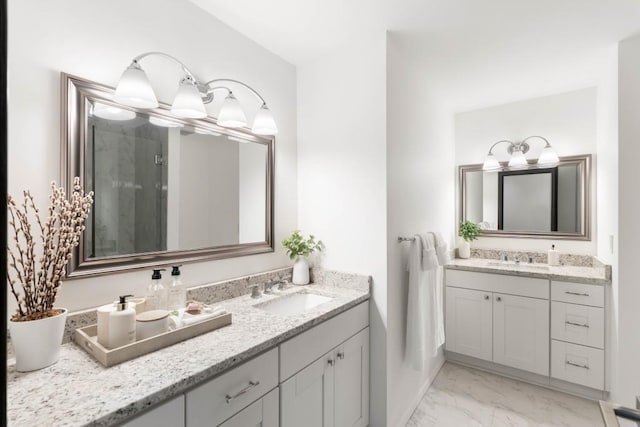 4070 Whitewater Creek Rd, Atlanta, GA 30327 - bathroom featuring two vanities, marble finish flooring, and a shower stall