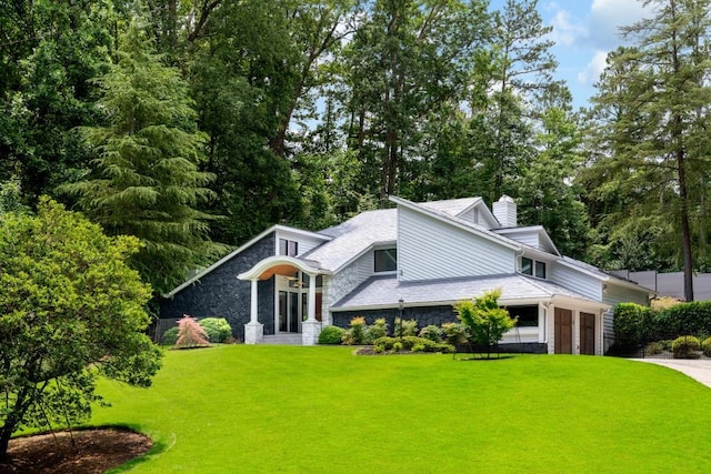 4070 Whitewater Creek Rd, Atlanta, GA 30327 - mid-century modern home with stone siding, a chimney, a front yard, and driveway