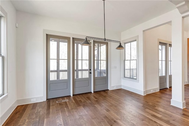 doorway with hardwood / wood-style flooring