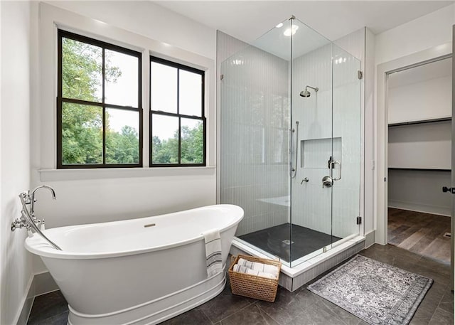 bathroom with independent shower and bath and a wealth of natural light