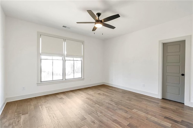 empty room with hardwood / wood-style flooring and ceiling fan