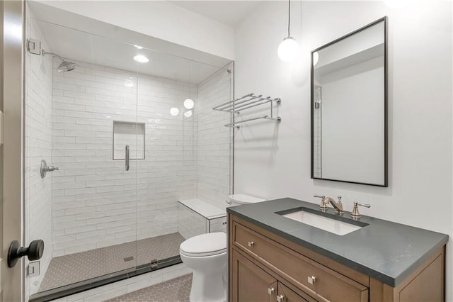 bathroom with vanity, toilet, and an enclosed shower