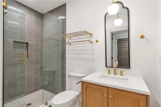 bathroom featuring vanity, toilet, and walk in shower