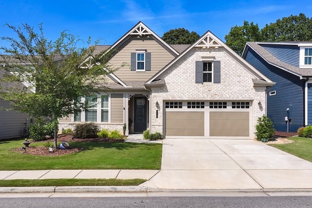 310 Chatuge Dr, Hoschton, GA 30548 - craftsman house with concrete driveway, a front yard, brick siding, and an attached garage