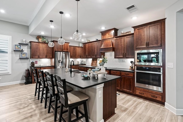 310 Chatuge Dr, Hoschton, GA 30548 - kitchen with appliances with stainless steel finishes, a sink, dark countertops, baseboards, and custom exhaust hood