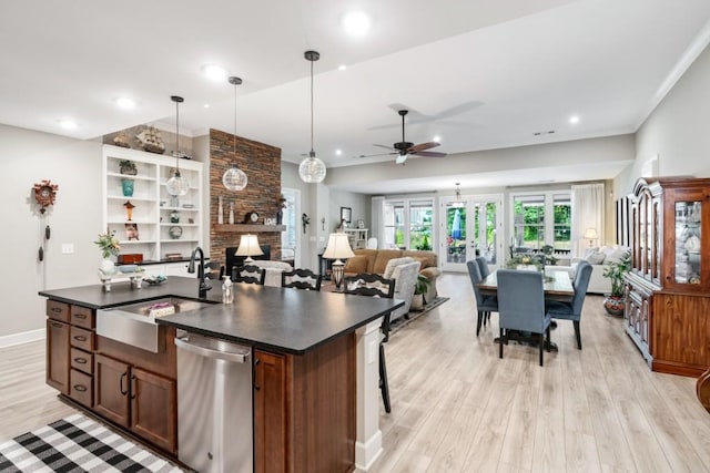 310 Chatuge Dr, Hoschton, GA 30548 - kitchen featuring a sink, stainless steel dishwasher, dark countertops, ceiling fan, and light wood-style floors