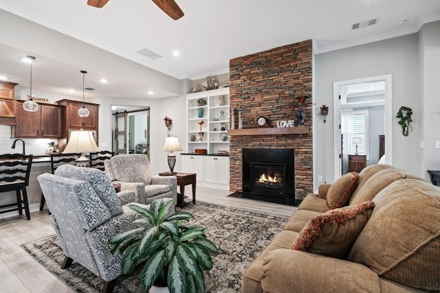 310 Chatuge Dr, Hoschton, GA 30548 - living area featuring a barn door, a ceiling fan, light wood-style flooring, crown molding, and recessed lighting
