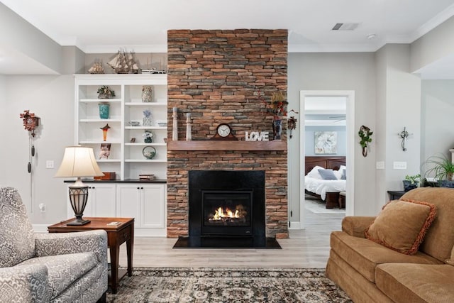 310 Chatuge Dr, Hoschton, GA 30548 - living area with light wood-style flooring, a fireplace, and ornamental molding