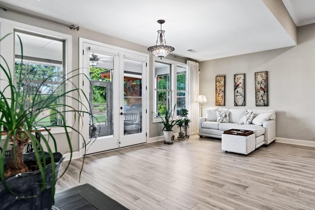 310 Chatuge Dr, Hoschton, GA 30548 - living area featuring light wood finished floors, baseboards, and french doors
