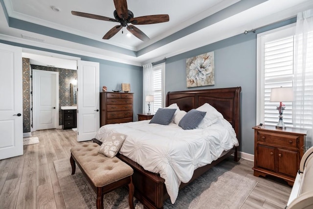 310 Chatuge Dr, Hoschton, GA 30548 - bedroom with a raised ceiling, light wood-style flooring, ornamental molding, connected bathroom, and recessed lighting