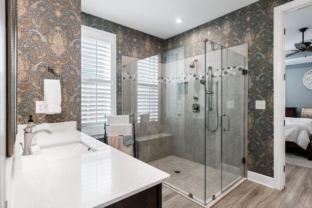 310 Chatuge Dr, Hoschton, GA 30548 - ensuite bathroom featuring healthy amount of natural light, vanity, wood finished floors, a stall shower, and recessed lighting