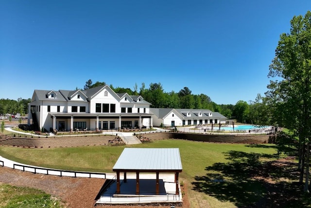 310 Chatuge Dr, Hoschton, GA 30548 - back of house featuring a lawn, an outdoor pool, and stucco siding