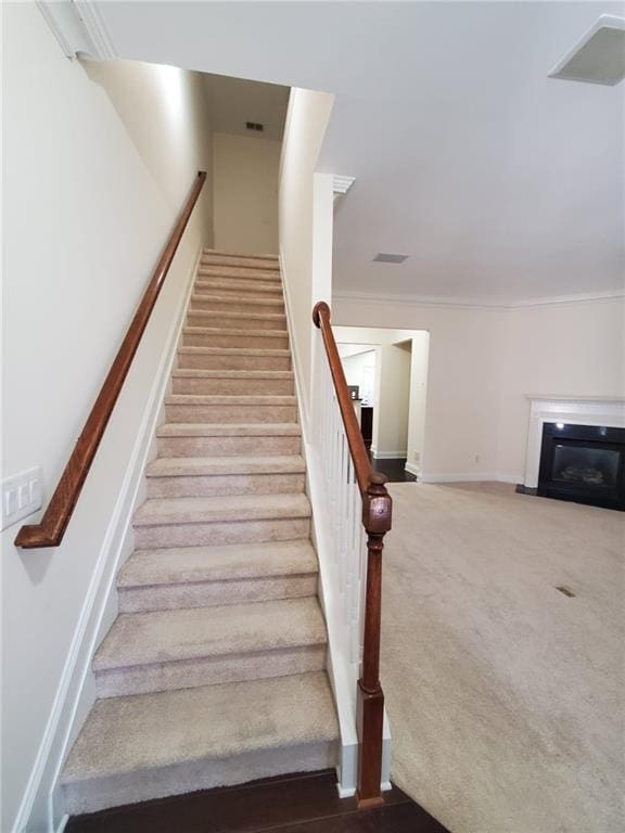 4215 Wildener Way, Cumming, GA 30041 - staircase with visible vents, baseboards, carpet, and a glass covered fireplace