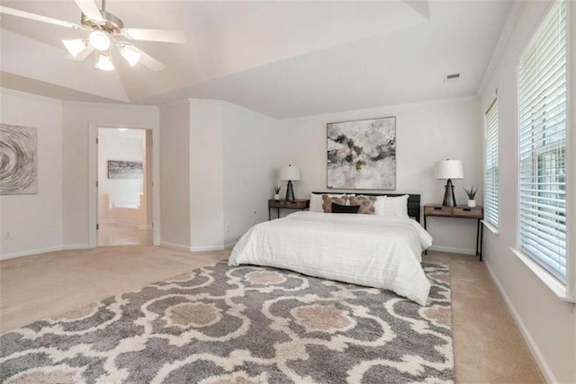 carpeted bedroom featuring ceiling fan, ornamental molding, ensuite bathroom, and multiple windows