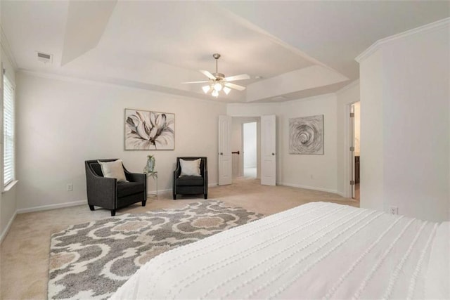 carpeted bedroom featuring a raised ceiling, ceiling fan, and crown molding