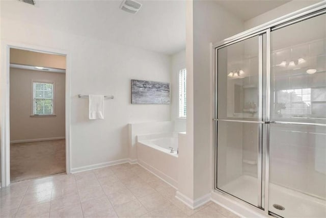 bathroom featuring separate shower and tub