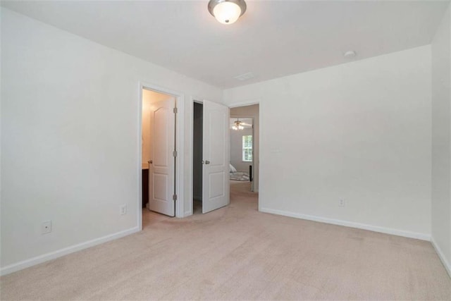 unfurnished bedroom featuring light colored carpet