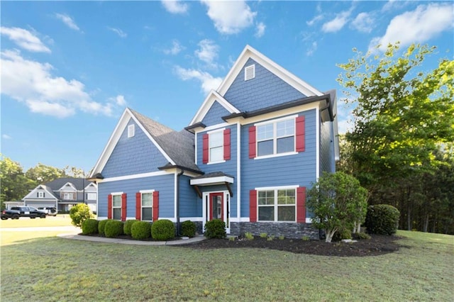 craftsman house with a front yard and stone siding