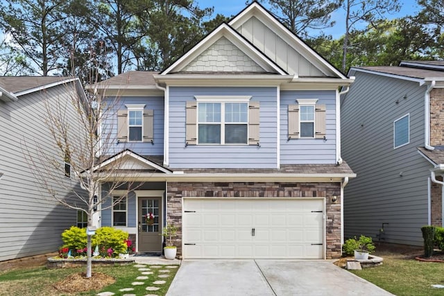 craftsman-style house featuring an attached garage, roof with shingles, driveway, and stone siding