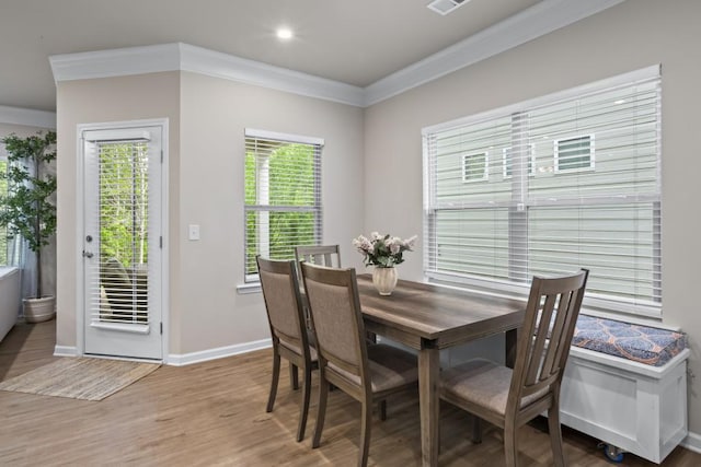 dining room with visible vents, baseboards, crown molding, recessed lighting, and wood finished floors