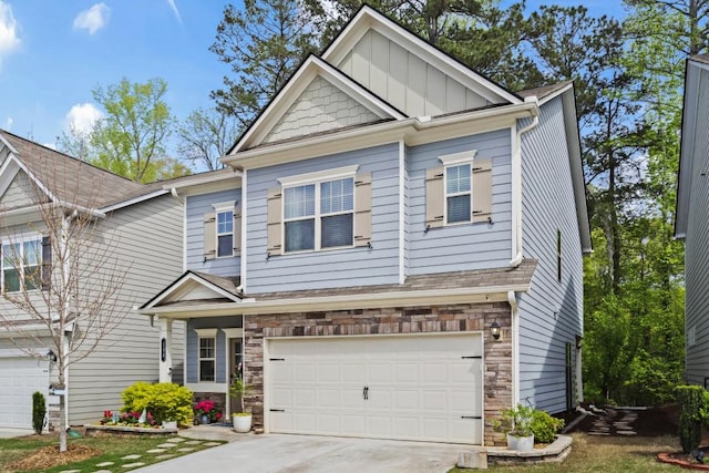 craftsman-style house with concrete driveway, stone siding, and an attached garage