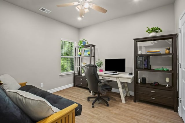 office featuring light wood-type flooring, ceiling fan, baseboards, and visible vents