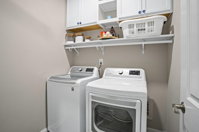 laundry room with cabinet space and washer and clothes dryer