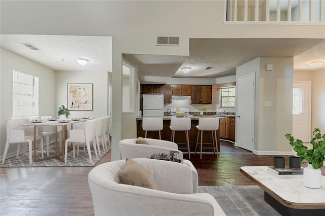 living room with dark wood finished floors and baseboards